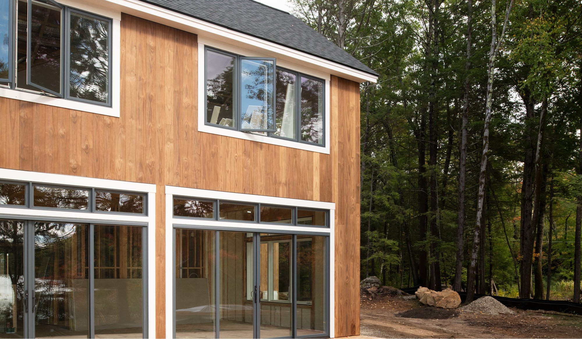 A wide exterior image of a home in Dublin, NH that uses Timber Trading ICON Radiata Pine siding.