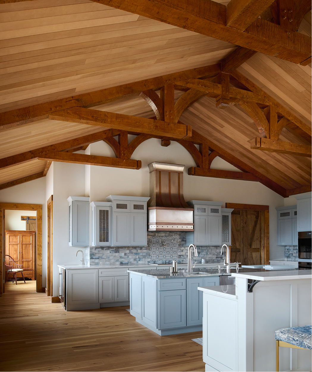 Photo of cathedral ceilings in a kitchen featuring Timber Trading wood.  