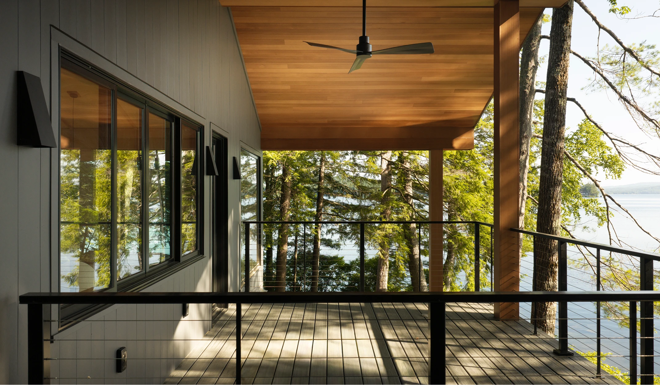 Image of porch ceiling, soffit, and wrapped beams on a modern home facing towards Little Lake Sunapee, NH